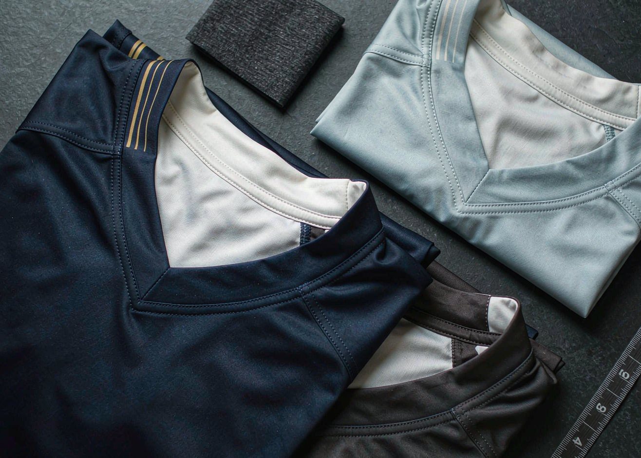 Football jerseys folded in a flat lay with a measuring tape - 2026/27 jersey buying guide